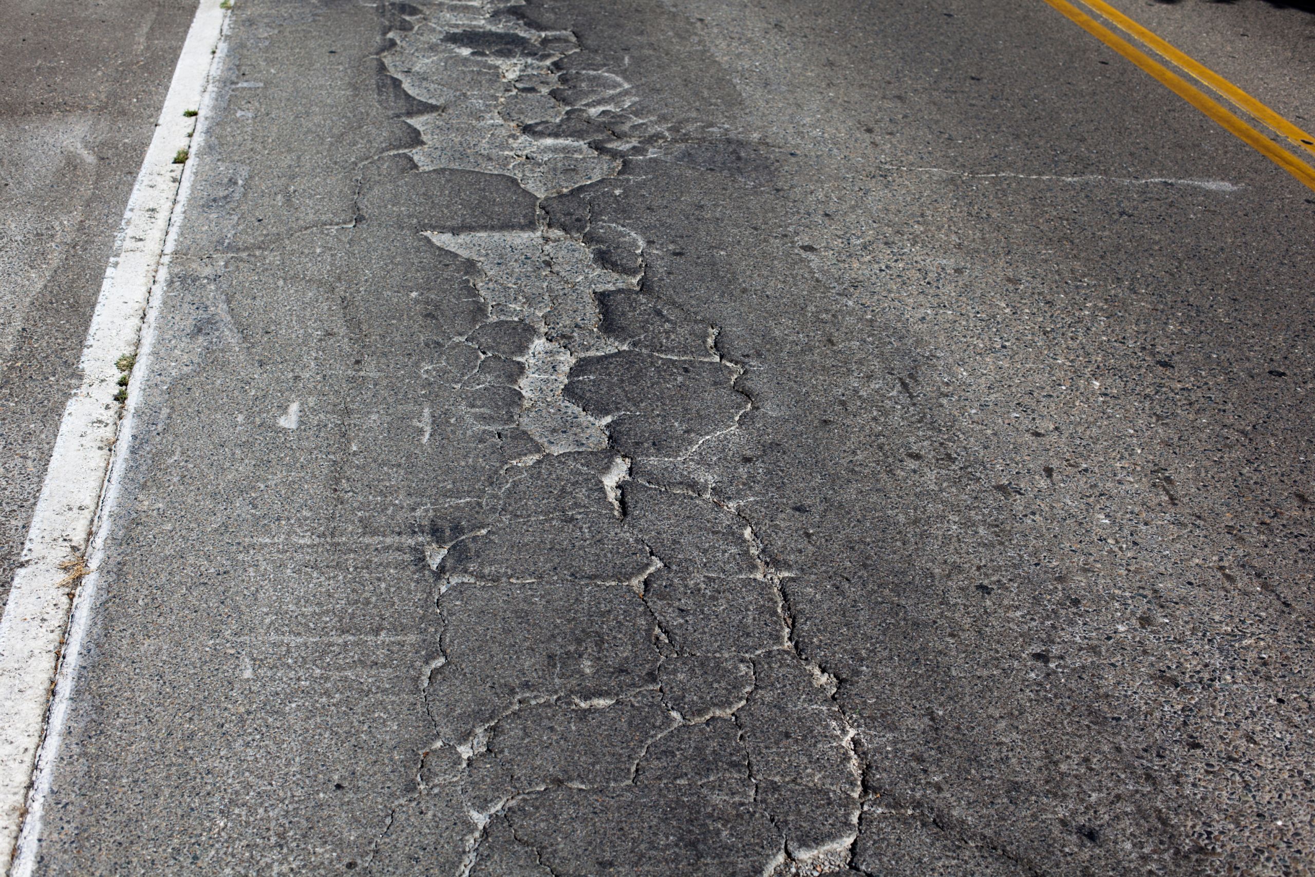 asphalt road that is damaged needing an effective asphalt repair method